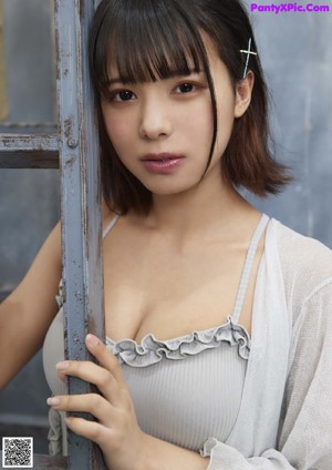 A woman standing on top of a ladder next to a wall.