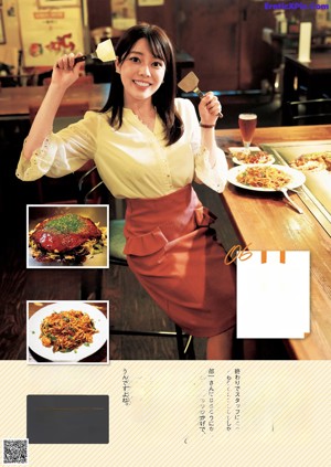 A woman sitting at a table with a plate of food and a drink.