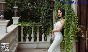 A woman in a silver dress standing on a road.