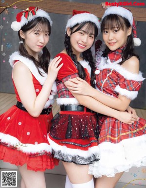 A group of girls in santa hats posing for a magazine cover.