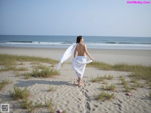 A woman with long brown hair wearing a white shirt.